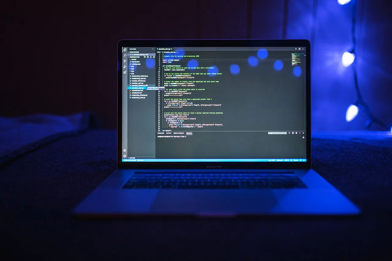 A laptop screen with programming code visible