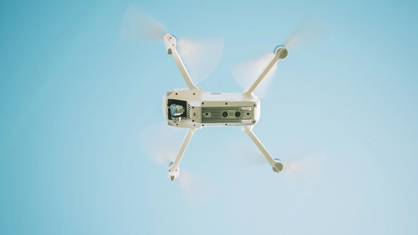 A delivery drone in flight against a clear sky